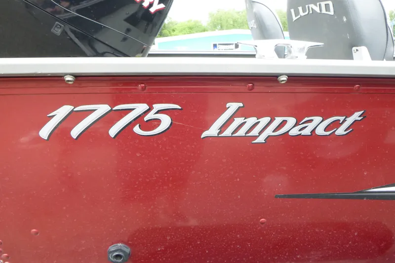 Slide: The Image of Red 2012 Lund 1775 Impact boat with logo and seating visible. - 17