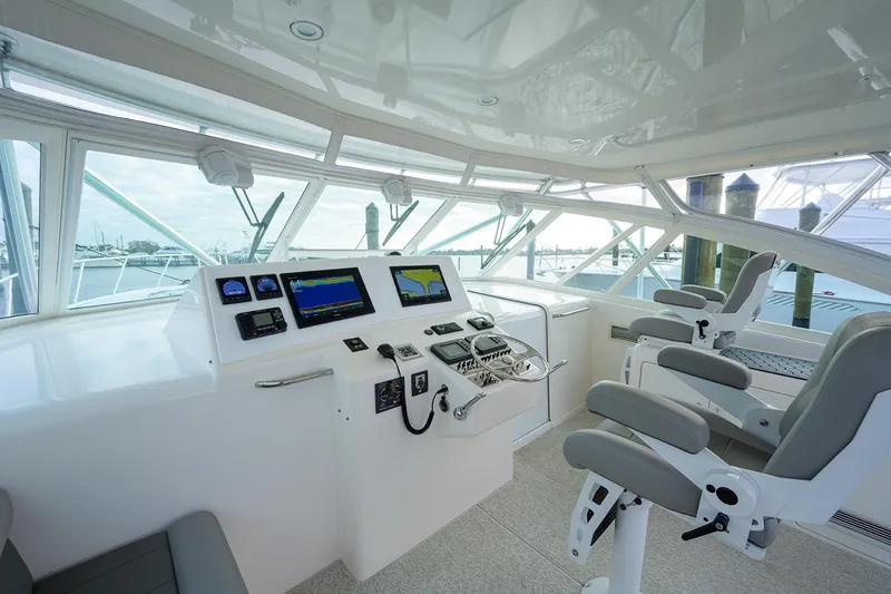 Slide: The Image of Interior of a 2005 Cabo Express boat with modern helm console. - 17