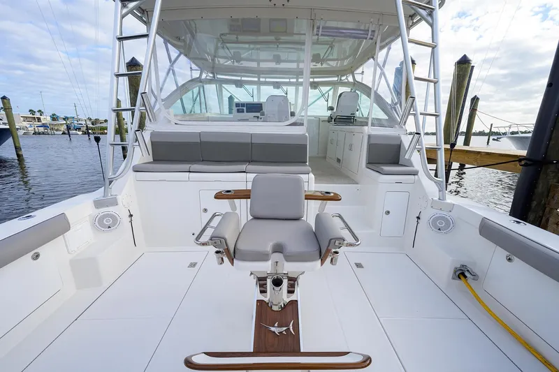 Slide: The Image of 2005 Cabo Express boat at dock with seating area. - 23