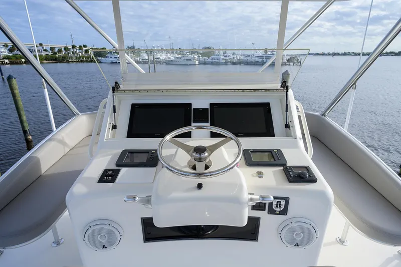 Slide: The Image of Helm of a 2005 Cabo Express yacht on the water. - 28