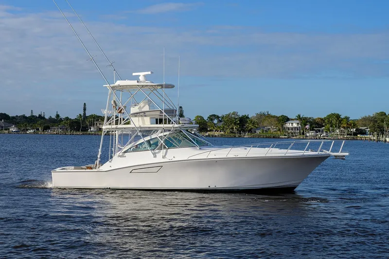 Slide: The Image of 2005 Cabo Express boat on calm water. - 42