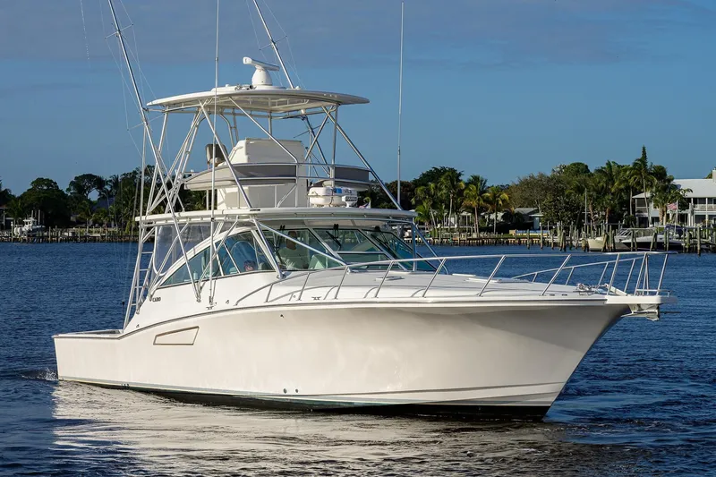 Slide: The Image of 2005 Cabo Express boat on calm water. - 43
