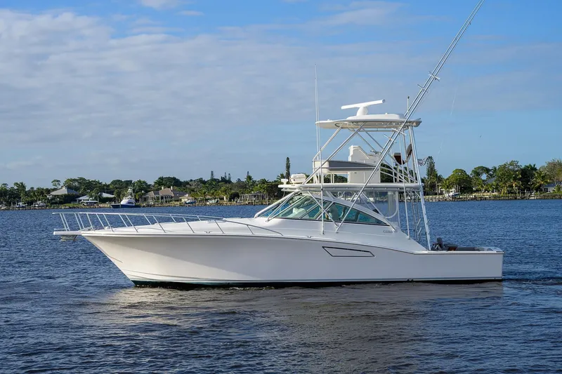 Slide: The Image of 2005 Cabo Express boat on calm water. - 46