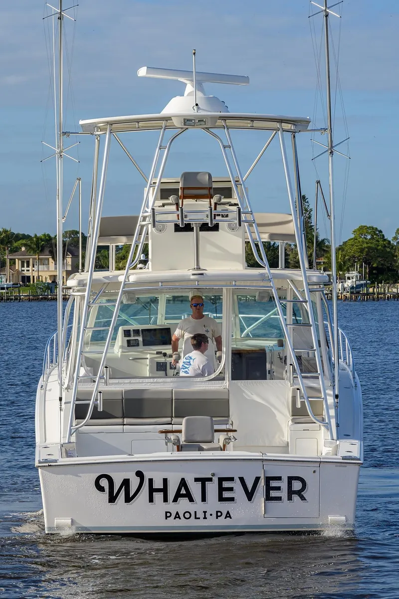 Slide: The Image of Cabo Express 2005 boat on water with two people aboard. - 48