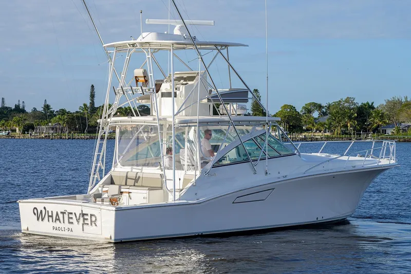 Slide: The Image of 2005 Cabo Express boat on calm water. - 49