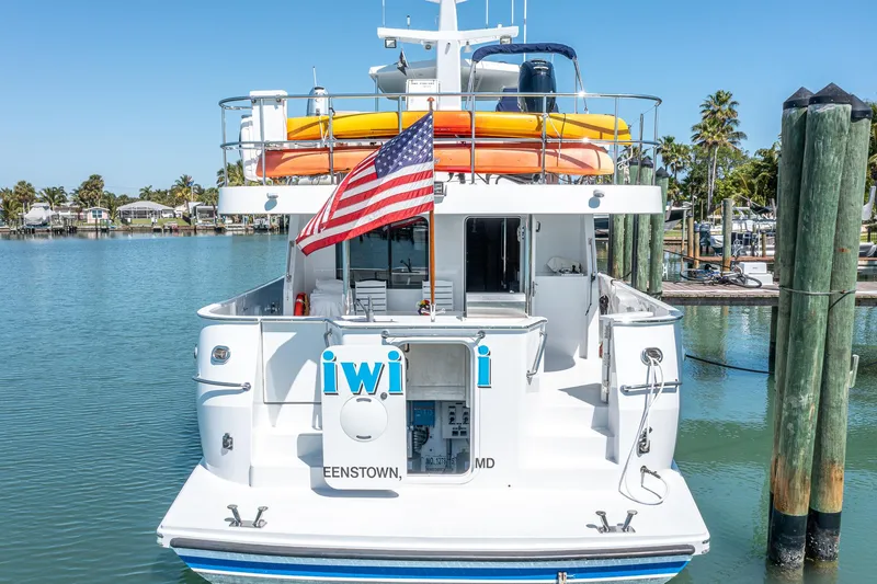 Slide: The Image of 2017 Northern Marine Expedition yacht docked, displaying an American flag and vibrant kayaks. - 10