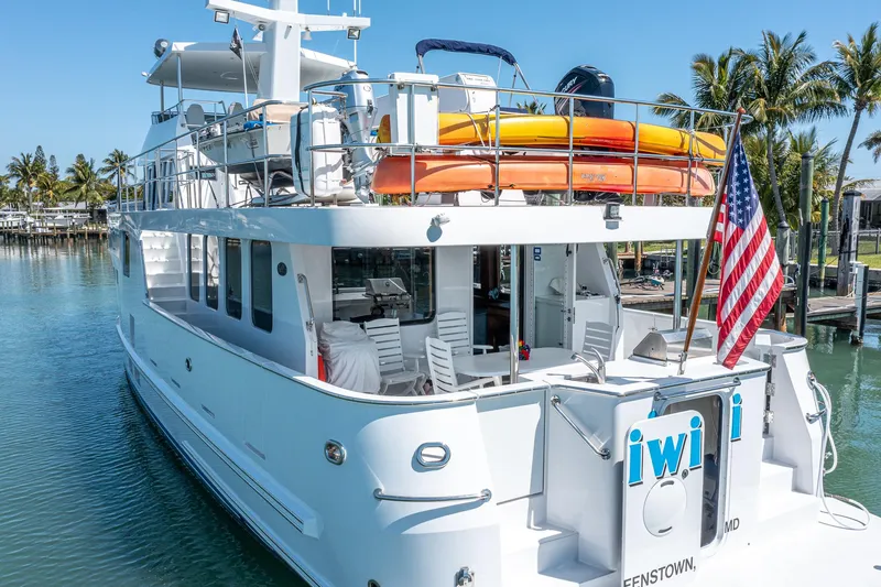 Slide: The Image of 2017 Northern Marine Expedition yacht docked, featuring kayaks and American flag. - 9
