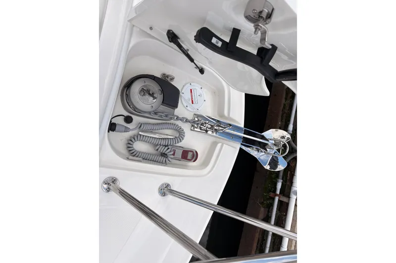 Slide: The Image of Anchor compartment of 2026 Sea Ray Sundancer 320 with coiled rope and winch. - 22