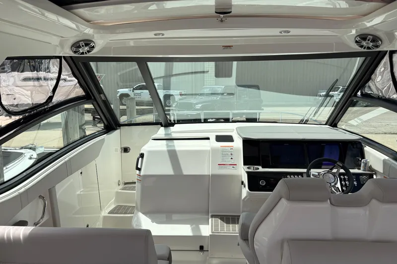 Slide: The Image of Interior view of 2026 Sea Ray Sundancer 320 yacht cockpit with modern controls and seating. - 11