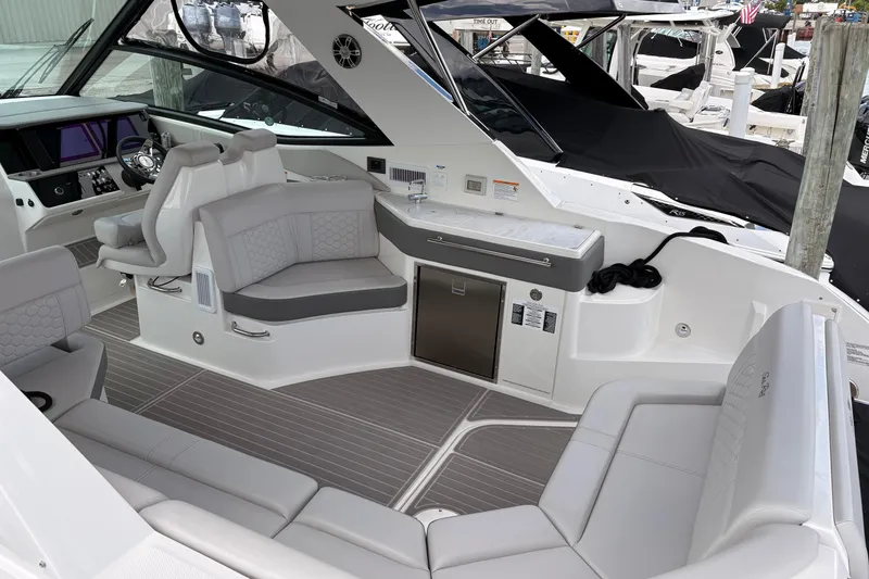 Slide: The Image of 2026 Sea Ray Sundancer 320 interior with modern seating and sleek design. - 10