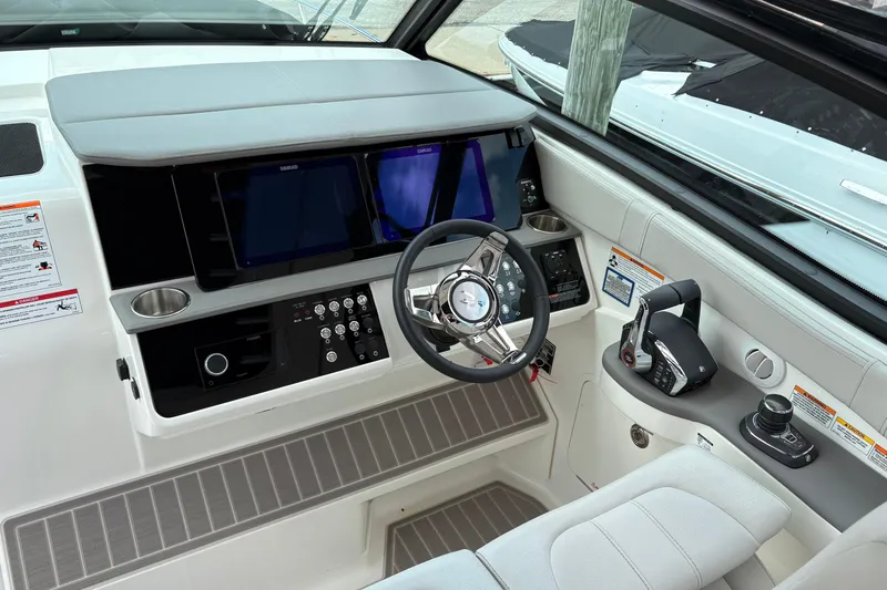 Slide: The Image of 2026 Sea Ray Sundancer 320 helm with modern controls and navigation displays. - 8