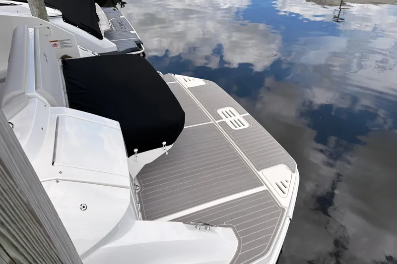Slide: The Image of 2026 Sea Ray Sundancer 320 swim platform reflecting sky on calm water. - 19