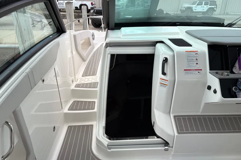 Slide: The Image of 2026 Sea Ray Sundancer 320 cockpit entrance with sleek design and modern features. - 13
