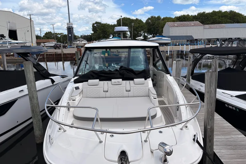 Slide: The Image of 2026 Sea Ray Sundancer 320 docked at marina, showcasing sleek design and spacious seating. - 3