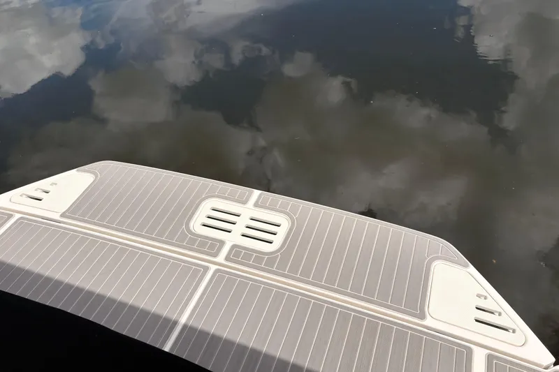 Slide: The Image of Swim platform of 2026 Sea Ray Sundancer 320 reflecting cloudy sky. - 20