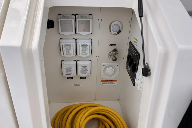 Slide: The Image of Electrical and water connections on a 2026 Sea Ray Sundancer 320 boat. - 21