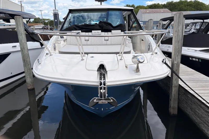 Slide: The Image of 2026 Sea Ray Sundancer 320 docked, showcasing sleek design and modern features. - 2