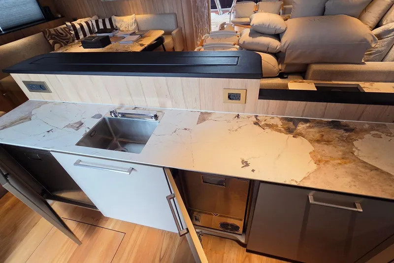 Slide: The Image of Modern kitchen in Moon 60 yacht, 2025 model, featuring marble countertop and stainless steel sink. - 11