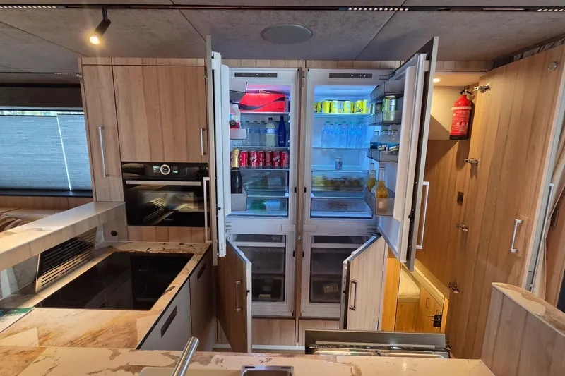 Slide: The Image of Modern kitchen in Moon 60, 2025 model, featuring open fridge and sleek appliances. - 12