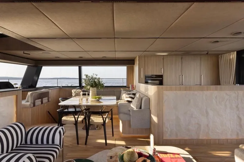 Slide: The Image of Luxurious interior of 2025 Moon 60 yacht with modern dining area and ocean view. - 14