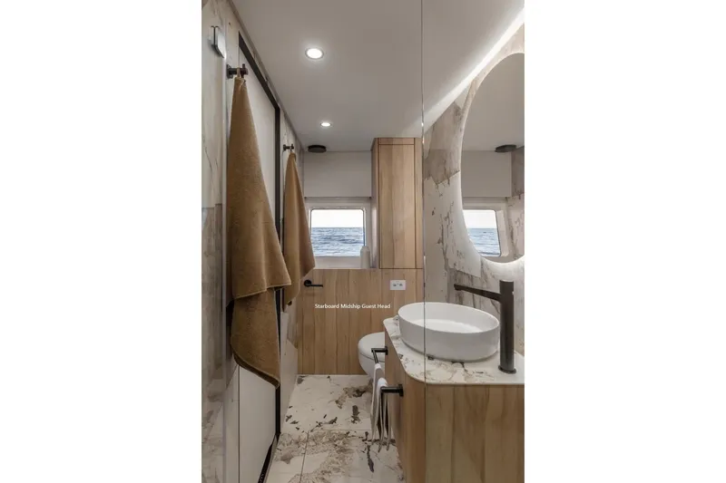 Slide: The Image of Luxurious yacht bathroom with ocean view, modern fixtures, and elegant design, Moon 60, 2025 model. - 19