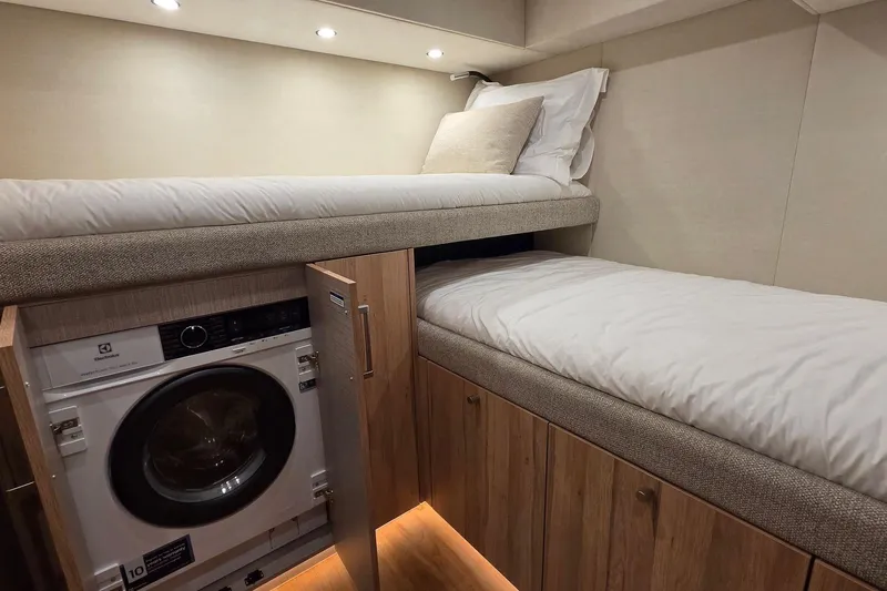 Slide: The Image of Compact cabin interior with bunk beds and built-in washing machine, Moon 60, 2025 model. - 20