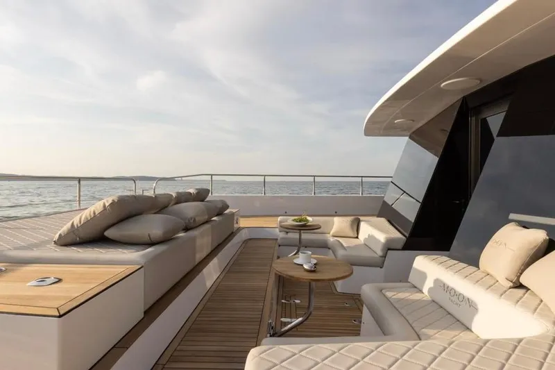Slide: The Image of Luxurious 2025 Moon 60 yacht deck with elegant seating and ocean view. - 26