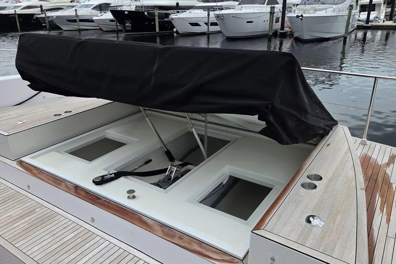Slide: The Image of Open hatch on 2025 Moon 60 yacht, docked with other boats in marina. - 27