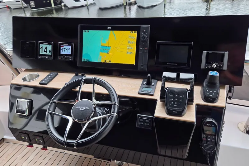Slide: The Image of Modern yacht control panel with navigation screens and steering wheel, Moon 60, 2025 model. - 30