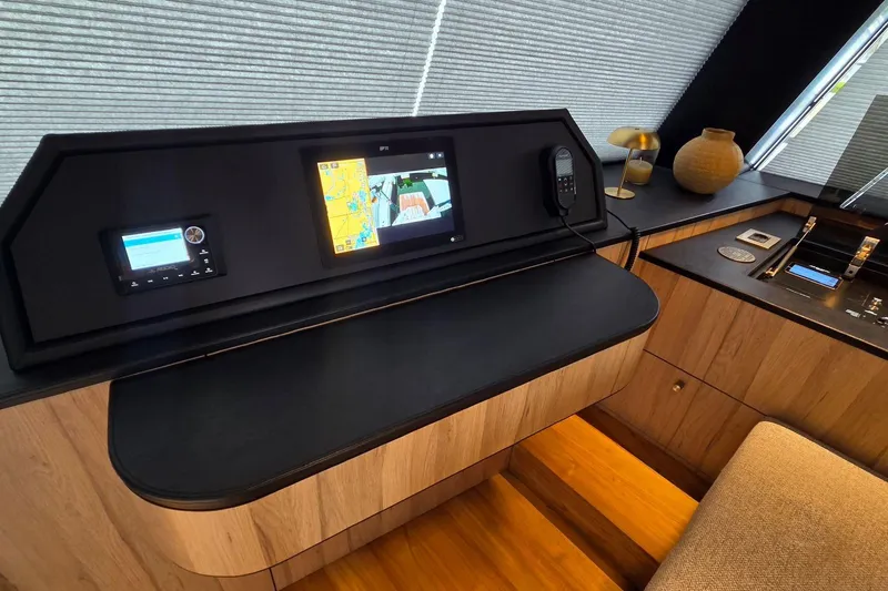 Slide: The Image of Modern control panel in 2025 Moon 60 yacht interior with navigation screens and sleek design. - 33