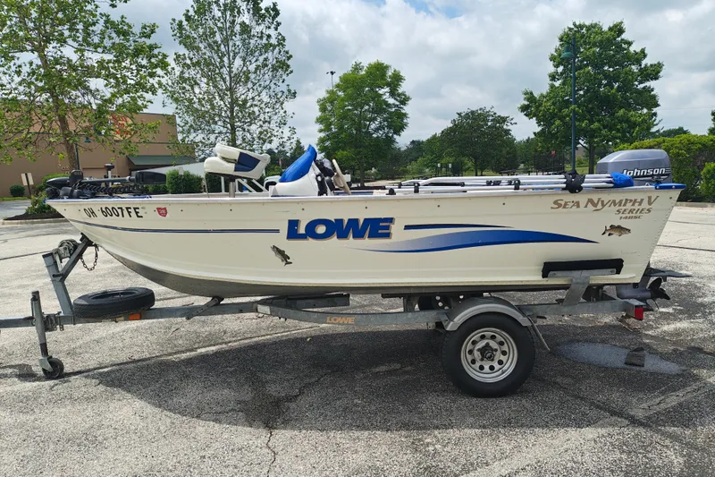 Slide: The Image of 1999 LOWE BOATS SEA NYMPH V-148SC on trailer in parking lot. - 0