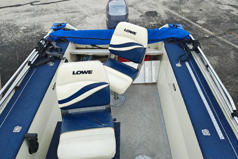Slide: The Image of 1999 LOWE BOATS SEA NYMPH V-148SC interior with blue and white seating. - 11