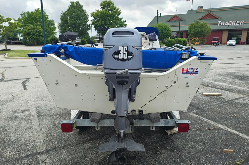 Slide: The Image of 1999 LOWE BOATS SEA NYMPH V-148SC with 35 HP motor in parking lot. - 2