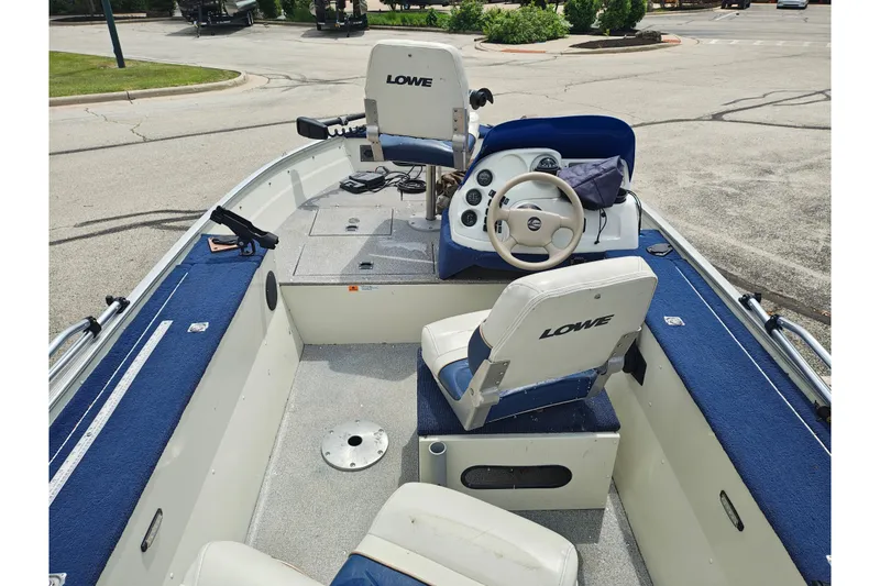 Slide: The Image of 1999 LOWE BOATS SEA NYMPH V-148SC interior with steering wheel and seating. - 3