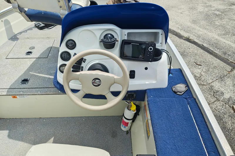 Slide: The Image of 1999 LOWE BOATS SEA NYMPH V-148SC dashboard with steering wheel and navigation equipment. - 4