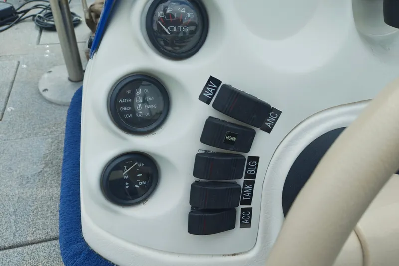 Slide: The Image of 1999 LOWE BOATS SEA NYMPH V-148SC dashboard with gauges and switches. - 5