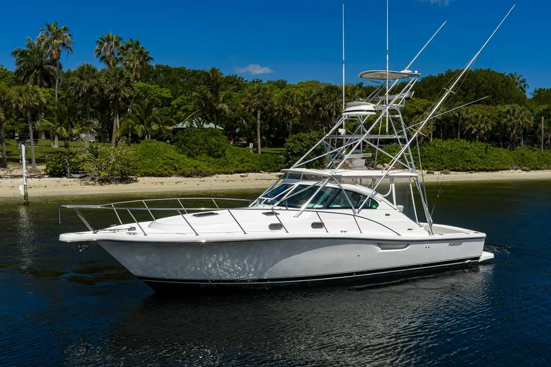Slide: The Image of 2004 Pursuit 3800 Express boat on calm water near a tropical shoreline. - 10