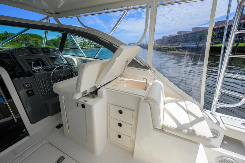 Slide: The Image of 2004 Pursuit 3800 Express yacht interior with helm, seating, and water view. - 17