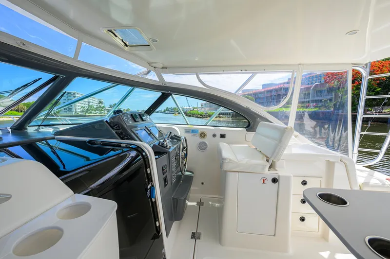 Slide: The Image of 2004 Pursuit 3800 Express yacht interior with helm, seating, and panoramic windows. - 18