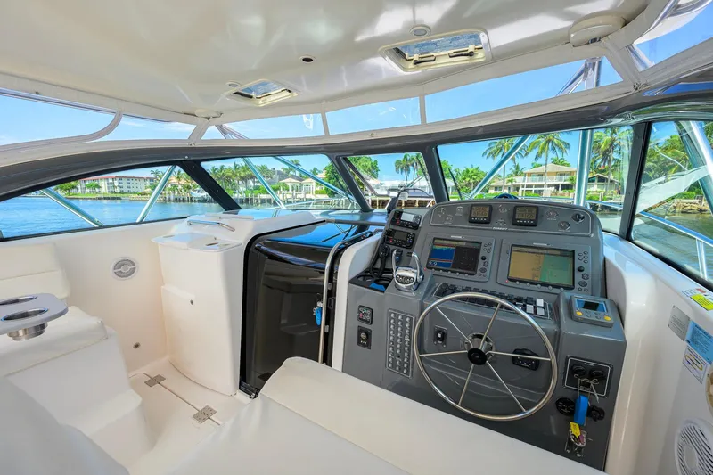 Slide: The Image of 2004 Pursuit 3800 Express yacht cockpit with modern navigation equipment and waterfront view. - 21