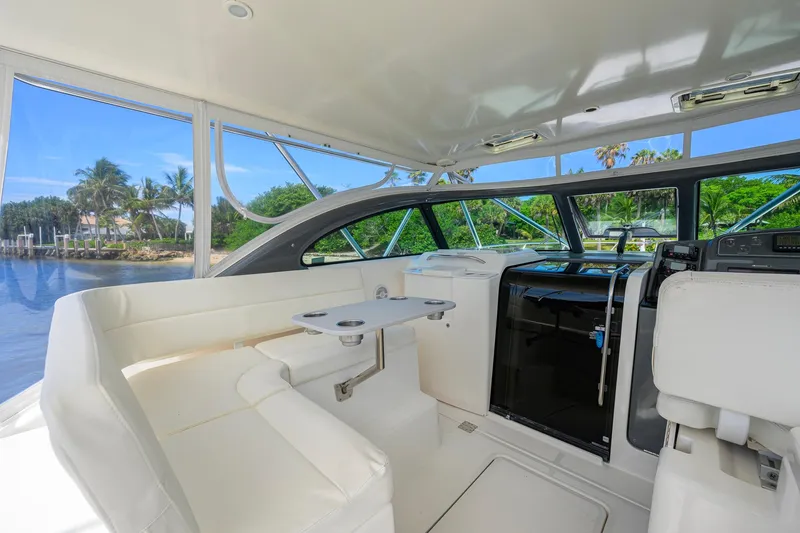 Slide: The Image of Interior of 2004 Pursuit 3800 Express yacht with white seating and scenic water view. - 24