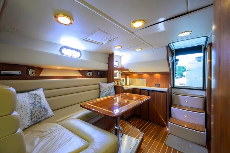 Slide: The Image of Luxurious interior of a 2004 Pursuit 3800 Express yacht with elegant seating and wooden finishes. - 28