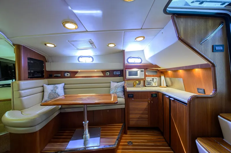 Slide: The Image of Luxurious interior of a 2004 Pursuit 3800 Express yacht with cozy seating and modern amenities. - 29