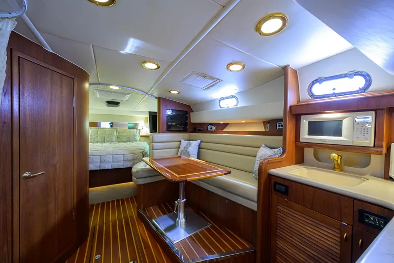 Slide: The Image of Luxurious interior of 2004 Pursuit 3800 Express yacht with kitchenette and seating area. - 30