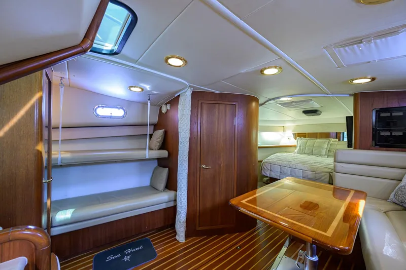 Slide: The Image of Luxurious interior of 2004 Pursuit 3800 Express yacht with wood finishes and cozy seating. - 34