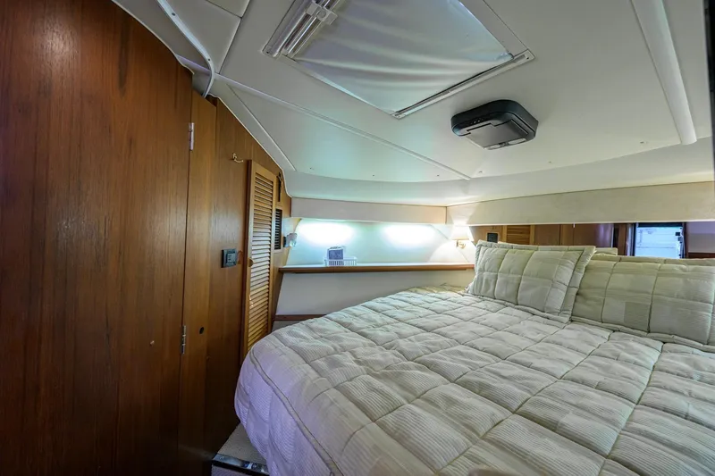 Slide: The Image of Luxurious cabin interior of 2004 Pursuit 3800 Express yacht with cozy bedding. - 37