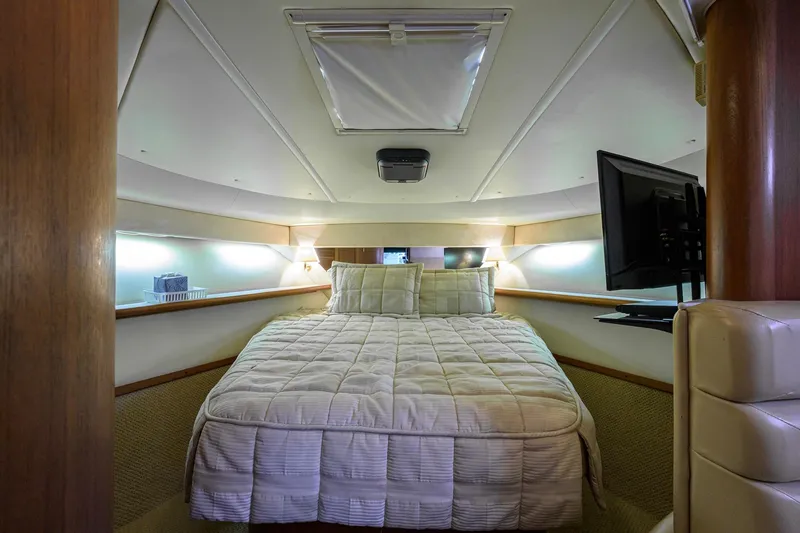 Slide: The Image of Luxurious cabin interior of 2004 Pursuit 3800 Express yacht with cozy bed and TV. - 38