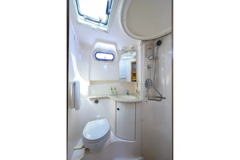 Slide: The Image of 2004 Pursuit 3800 Express yacht bathroom with shower, toilet, and sink. - 41