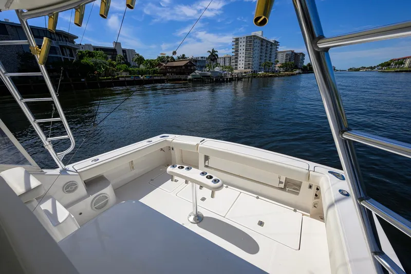 Slide: The Image of 2004 Pursuit 3800 Express boat deck overlooking waterfront buildings and clear blue sky. - 45