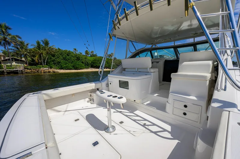 Slide: The Image of 2004 Pursuit 3800 Express yacht interior with seating, table, and ocean view. - 46